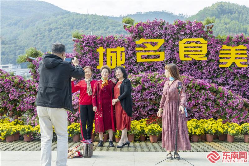 游客纷纷在菊花景观造型前拍照留念.jpg